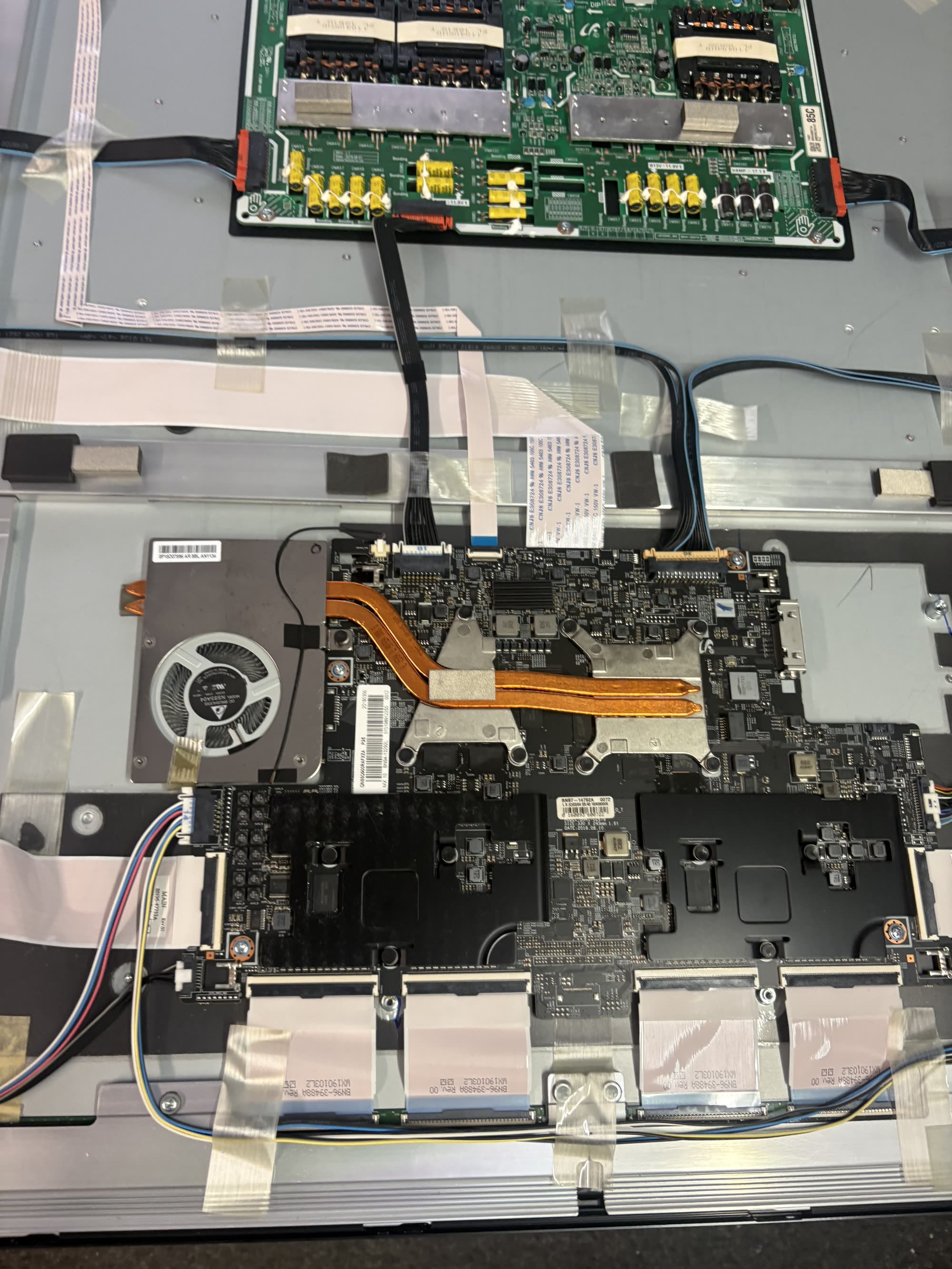 TV mainboard and T-con board close-up during repair